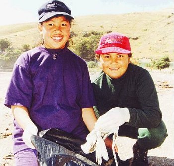 Doni Ranginui and Kylie JOhnston of Linwood North School, wave goodbye to rubbish at Taylor's Mistake during last year's Gigantic Clean Up.