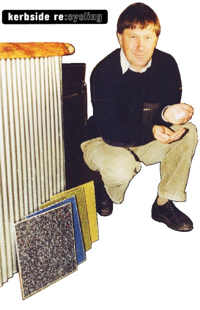 Kees de Vocht with recycled glass particles and a selection of tiles made from them.