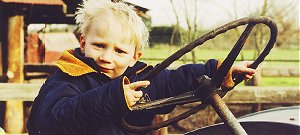 Three-year-old Sam Leeming Holmes,of Christchurch,has one of his first tastes of drivingan old tractor at Willowbank Wildlife Reserve.