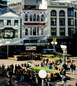 An audience gathers at the City Mall amphitheatre to hear a free Kids in Town concert