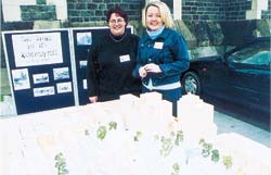 Tina Dunnings and Michelle Rouxel with a cardboard mockup of the square